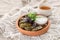 Dolma grape leaves with sauce on a clay plate on the table