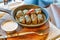 Dolma in a pan on a wooden stand with cutlery, close up