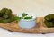 Dolma on wooden plate with mint and sour cream side view