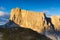 Dolomite Alps, Italy. View of the mountains and high cliffs during sunset. High sharp rocks and soft sunshine. Natural landscape.