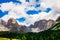 Dolomite rocky mountains of Trentino Alto Adige from the green valley on a summer day with some clouds