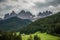 Dolomites, Italy - July, 2019: Famous best alpine place of the world, Santa Maddalena village with Dolomites mountains in