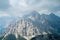 Dolomites rocky tower mountains the Alps with dark clouds