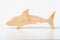 Dolphin figurine carved from solid pine by hand jigsaw. On a white background