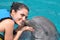 Dolphin kiss young woman