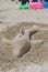 Dolphin made of sand on the beach of the Balearic Sea