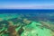 Dolphins, sharks, stingray in caribbean sea pool park. Swimming with fish. Aerial view