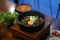 Dolsot bibimbap - Korean mixed rice, Include steamed rice, vegetables, pork and fried egg on top, served in a hot stone pot