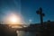 Dom Luis I bridge in backlit at sunset with the cross in an abandoned chapel in the foreground, Porto