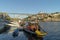 Dom Luis I Bridge over the river Duoro with rabelo boat in the city of Porto, Portugal