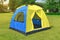 Dome camping tent for family on isolate green field.