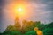 The dome of the church at sunset. Chapel in the green leaves of trees