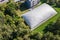 Dome of inflatable tennis court in park in summer. aerial view