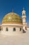 The dome and minaret of a mosque in the desert of Oman