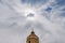 The dome of the old church. Symbolic sign on background with sun in cloudy sky