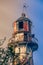 Dome of an old rusty metal lighthouse in the sun rays. Toned image