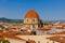 Dome of San Lorenzo Basilica under blue sky, over houses of the historical center of Florence, Italy