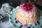 Dome shaped cake topped with pomegranate