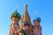 Dome of St. Basil`s Cathedral on a blue sky background. Sunny morning in Moscow