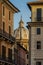 The dome of a temple between old antique houses among small streets of Rome