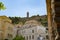 Domed roof of town hall below historic stone wall