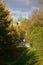 Domes of the church of Archangel Michael. Trees with yellow leaves, bridge over the ravine. Golden autumn Indian summer in Yaros