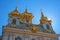 The domes of the church building. The domes are covered with gilding, they are crowned with crosses. Petergof, Russia