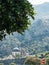 Domes of the Church of St. Nicholas among the trees at the foot of the mountains. Kotor, Montenegro