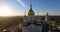 Domes of the church at sunrise. Aerial shooting from quadrocopter above the sky. Aerial view of Pochaev Monastery