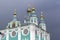 Domes of the Orthodox Cathedral in the background of a dark thundercloud.