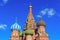 Domes of St. Basil`s Cathedral against blue sky