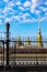 The domes of St. Peter and Paul cathedral seen through the fence of Museum of Artillery.