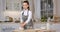 Domestic baking. Young woman confectioner preparing pastry at home, beating eggs for dough, standing at kitchen