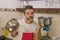 Domestic chores stress - lifestyle portrait of young attractive overworked and stressed home cook man in red apron hating