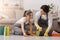 Domestic Cleaning. Happy millennial couple washing floor at home together