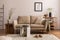 Domestic and cozy interior of living room with beige sofa, plants, shelf, coffee table, boucle rug, mock up poster frame, side