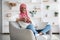 Domestic Leisure. Black Muslim Lady Relaxing At Home With Laptop And Coffee