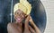 Domestic lifestyle mirror reflection portrait of young beautiful black afro American woman wet after having a shower with her head