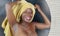 Domestic lifestyle mirror reflection portrait of young beautiful black afro American woman wet after having a shower with her head