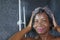 Domestic lifestyle portrait of young happy and beautiful black African American woman smiling happy taking a shower at home