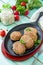 Domestic meat cutlet with white beans and fresh herbs. Cast-iron frying pan full of delicious fried meat cutlets, fresh greens and