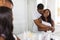 Domestic Morning. Happy Young Black Spouses Embracing Near Mirror In Bathroom