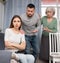 Domestic quarrel - husband and mother try to calm crying wife