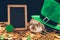 domestic rabbit sitting on golden coins under green hat, st patricks day concept