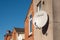 Domestic satellite dish on traditional british house wall