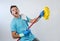 Domestic service man or happy husband cleaning home playing with mop air guitar having fun