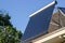 Domestic solar panel on a roof, with clear, cloudless sky