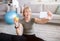 Domestic sports and healthy diet concept. Cheerful mature woman taking selfie with apple after home workout, indoors