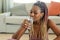 Domestic sports and hydration. Young african american woman drinking fresh water from glass, resting after exercising