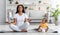 Domestic Sports. Smiling African American Woman Meditating With Little Son At Home